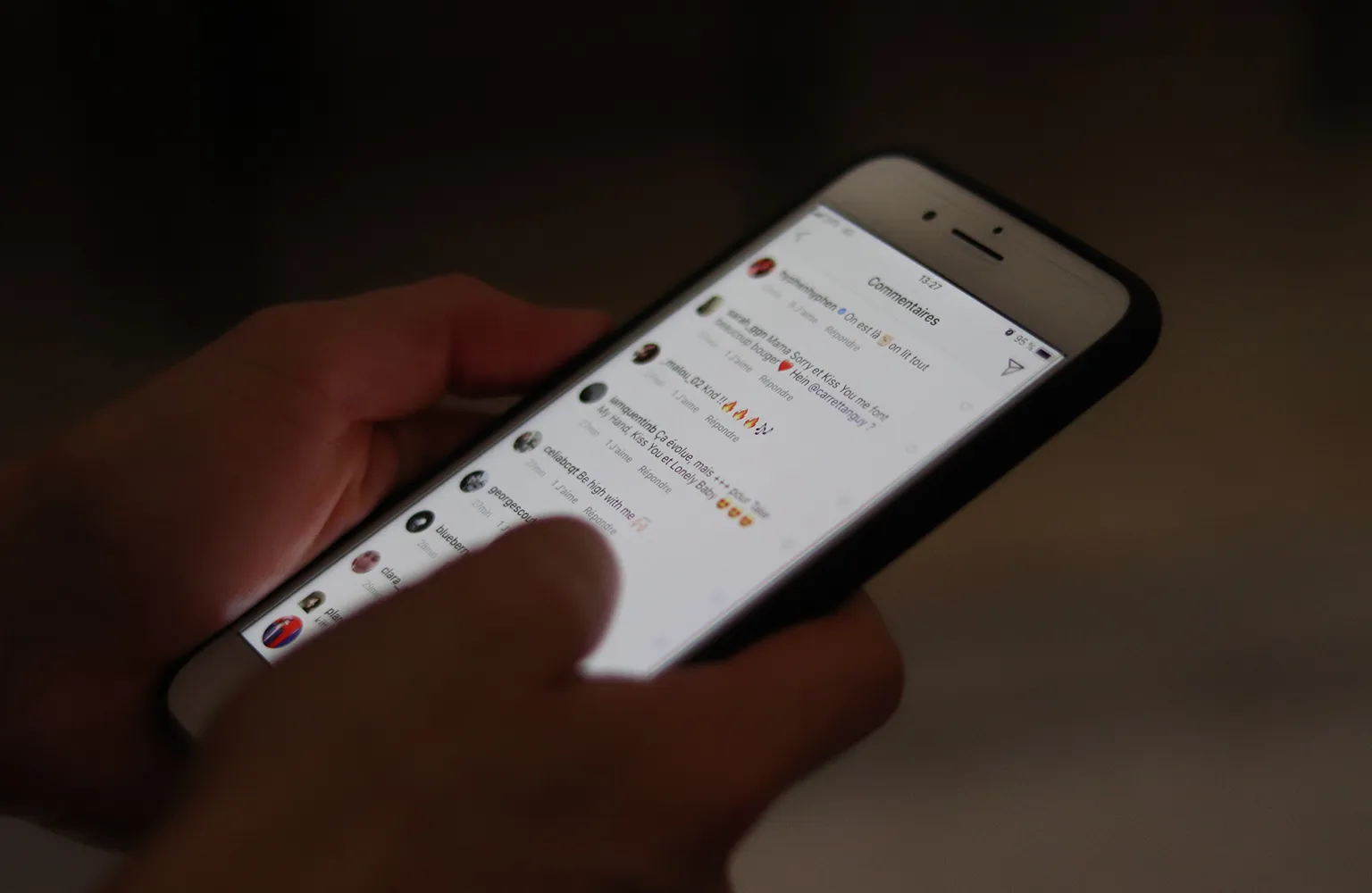 A person holding a smart phone displaying a text message with a short love quote for him.