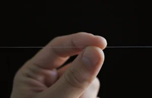 A person holds a string, illustrating the essence of success and motivational quotes that resonate deeply.